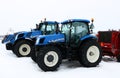 New Holland tractors lined up for sale on grey winter day