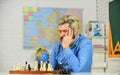 Chess Academy. Focused school teacher. thinking of attacking and capturing opponent chess pieces. thinking of next move Royalty Free Stock Photo