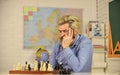 Chess Academy. Focused school teacher. thinking of attacking and capturing opponent chess pieces. thinking of next move Royalty Free Stock Photo