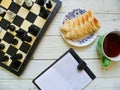 chess, apple pie, a cup of tea and a notebook