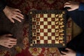 Chess battle between old and young generations. Top view chessboard with hands Royalty Free Stock Photo