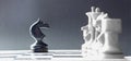 A chess black horse is standing opposite the white chess of the opponent. Symbol of leadership and confrontation