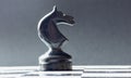 A chess black horse is standing opposite the white chess of the opponent. Symbol of leadership and confrontation