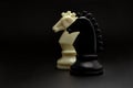 Chess. Black and White Knights on black background. Royalty Free Stock Photo