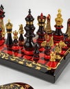 Chess board with black and red figures on a white background Royalty Free Stock Photo