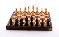 Chess board with black and white figurines on a white background