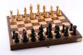 Chess board with black and white figurines on a white background Royalty Free Stock Photo