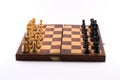 Chess board with black and white figurines on a white background Royalty Free Stock Photo