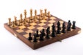 Chess board with black and white figurines on a white background Royalty Free Stock Photo