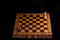 Chess board with black and white pawn. Only pawns on a chessboard on a black background, confrontation Royalty Free Stock Photo