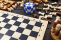 Chess board and chess figures, wooden cubes, puzzle games on dark wooden table. Popular logic games for logical thinking