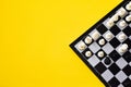 Chess and chess board on yellow background Royalty Free Stock Photo