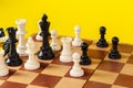 Chess board with figures on yellow background top view copy space Royalty Free Stock Photo