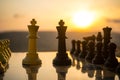 chess board game concept of business ideas and competition and strategy ideas. Chess figures on a chessboard outdoor sunset backgr Royalty Free Stock Photo