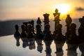 chess board game concept of business ideas and competition and strategy ideas. Chess figures on a chessboard outdoor sunset backgr Royalty Free Stock Photo