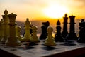 chess board game concept of business ideas and competition and strategy ideas. Chess figures on a chessboard outdoor sunset backgr