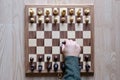 Chess board game. A hand playing chess. The fight begin. Business strategy and competition concept. Top view. Flat lay