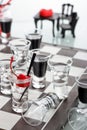 Chess board with shot glasses Royalty Free Stock Photo