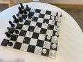 A chess board on a table in a recreation room at a luxury apartment building