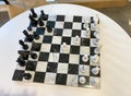 A chess board on a table in a recreation room at a luxury apartment building