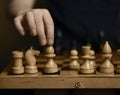 chess board white and black pieces a child& x27;s hand takes a chess piece of a white elephant with children& x27;s Royalty Free Stock Photo