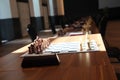 Chess boards on tables during Chess Championship. The tournament. Chess board with white, black pieces and clock on desk. Plan lea