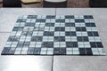 Chess or checker board made with pieces of glass, some broken, in white and black colors Royalty Free Stock Photo