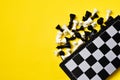 Chess and chess board on yellow background Royalty Free Stock Photo