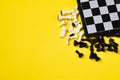 Chess and chess board on yellow background Royalty Free Stock Photo