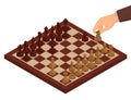 Chess. Chessboard, chessmen on it and hand holding chess knight. Isometric view Royalty Free Stock Photo