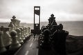Chess concept of business and strategy ideas. Silhouette of a man standing in the middle of the road with giant chess figures and