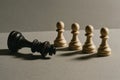 Chess concept of fallen king and standing pawns symbolizing defeat and strategy Royalty Free Stock Photo