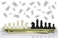 Chess face each other on a dollar banknote and dollar is falling from the top.