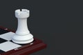 Chess figure rook on chess board on black background Royalty Free Stock Photo