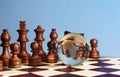 Chess figures against earth globe Royalty Free Stock Photo