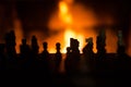 Chess figures silhouette with fire in the background Royalty Free Stock Photo