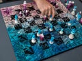 Chess game on a chessboard decorated in pink and blue with pieces with floral motifs Royalty Free Stock Photo