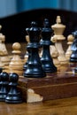 Chess game, close up of a black king and queen, other figures in the front Royalty Free Stock Photo