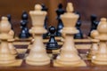 Chess game, close up of a black pawn, white figures in the front