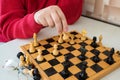A chess game, a close up of a mans hand and chess