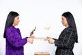 Chess game over. Brunette girls toss chess pieces on the chessboard. White background. Royalty Free Stock Photo