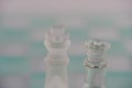 Chess with game pieces made of glass, queen, king, pawn and game board made of glass Royalty Free Stock Photo