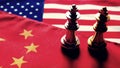 Chess game. Two kings face to face on Chinese and American national flags. Trade war and conflict between two big countries. USA