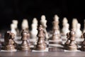 Chess game. White and black pieces are fighting for victory. The Central figure is in focus.