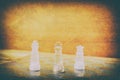 Chess glass on board in game. On a vintage wooden floor background vintage scratched old film colors. Concept competition business