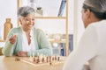 Chess, happy and senior couple play games for relaxing, bonding and spending time together at home. Marriage, retirement Royalty Free Stock Photo