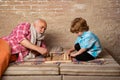 Chess hobbies - granddad with grandson on a playing chess. Generations. Kid Playing Chess. Grandfather playing chess Royalty Free Stock Photo