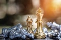 Chess king and bishop stood on chessboard surrounded by other pieces lying on their opponent\'s side. Strategic Ideas to beat Royalty Free Stock Photo