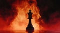 Chess king piece silhouette against fiery background with dramatic lighting effects Royalty Free Stock Photo