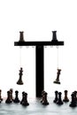 Chess king and queen hanging from a simulated gallows